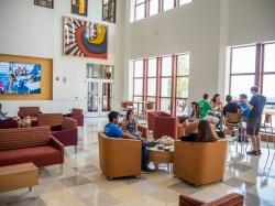 students seated and talking in common area