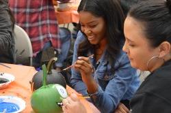 students painting pumpkins